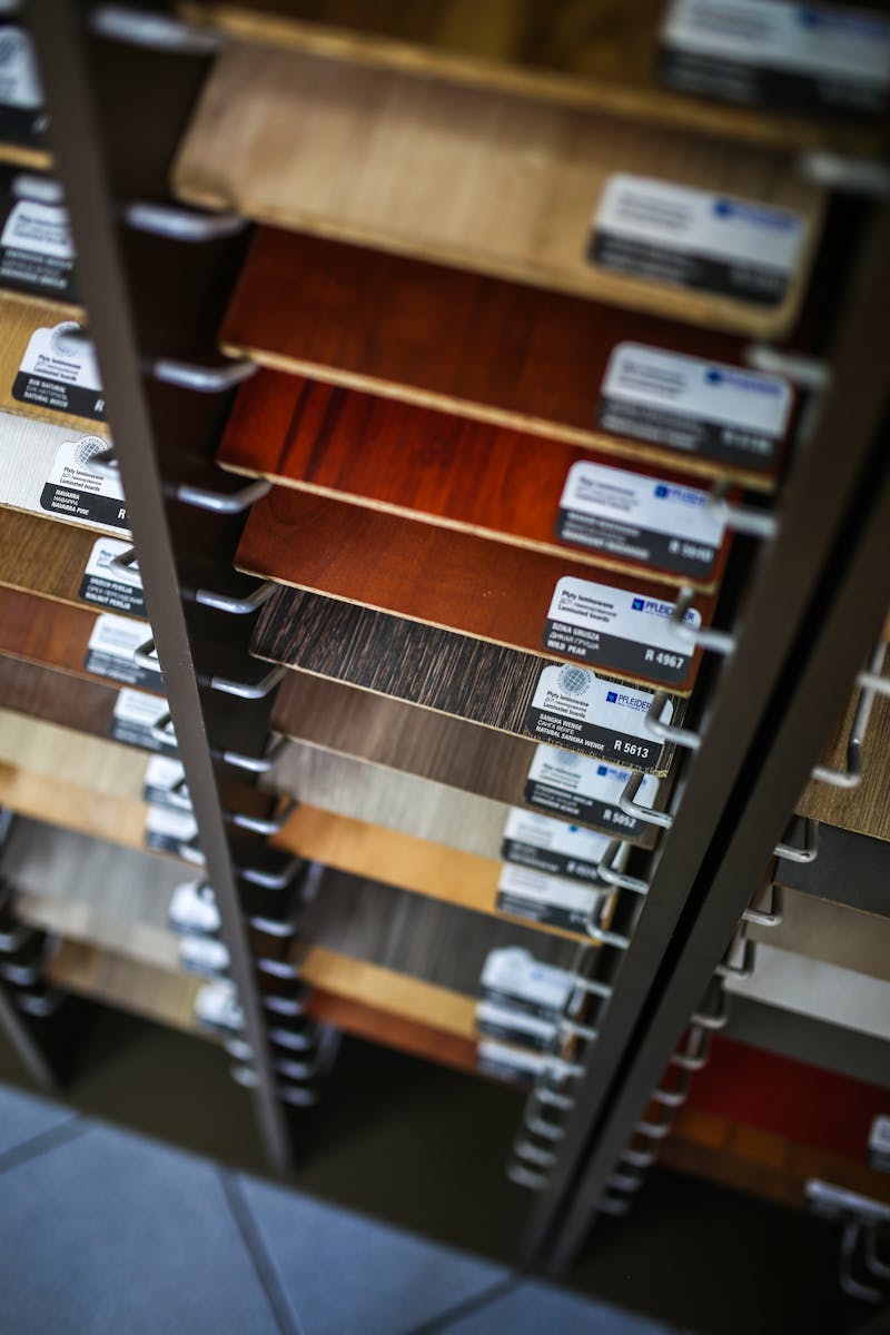 A collection of laminated wood samples organized in a vertical display rack for selection.